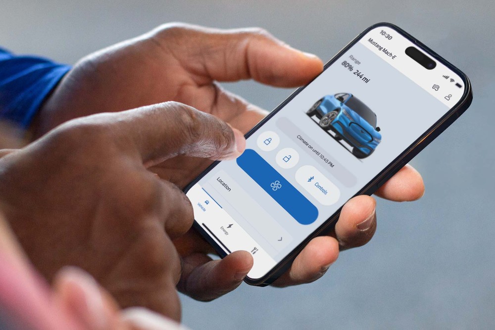 Homem a segurar num telemóvel a fazer a trancagem remota na aplicação FordPass