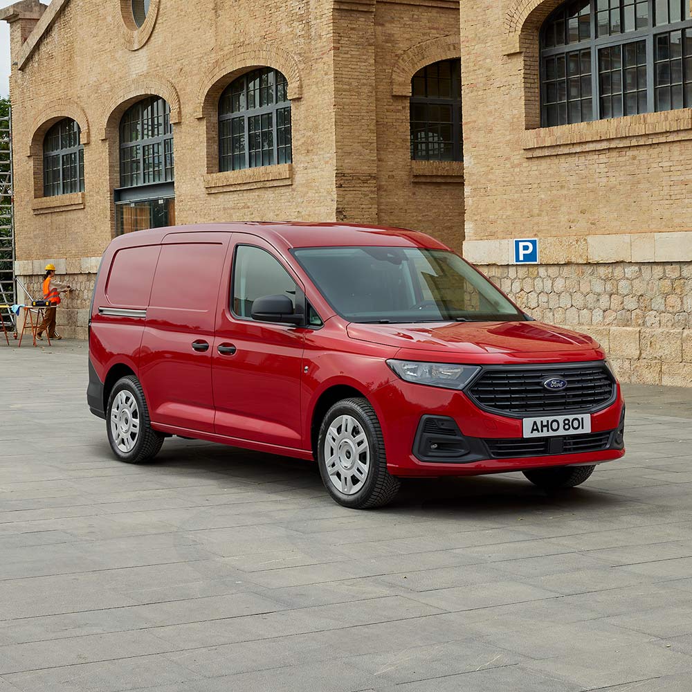 Ford Transit Connect Trend em Lava Red, a mostrar a grelha dianteira e os faróis automáticos.